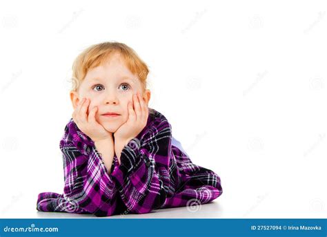 A Little Girl In A Dress Looking From The Side Thinking Stock Photo