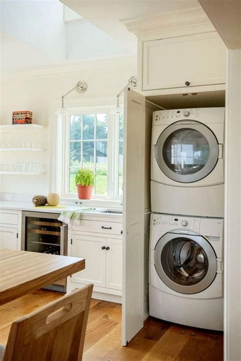 Beck placed a combination washer and dryer unit in a cabinet. Laundry Nook In Kitchen - how to hide washer and dryer in ...