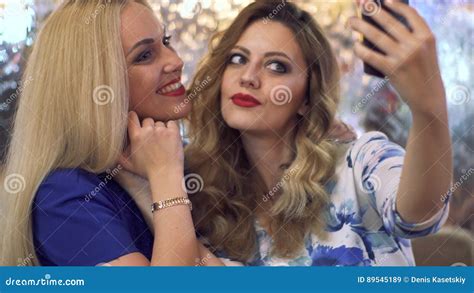 Carefree Teen Girls Making Funny Faces And Smiling For Selfies Stock