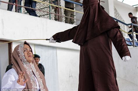 suspected prostitutes caned during mass flogging that leaves man s back red raw in indonesia