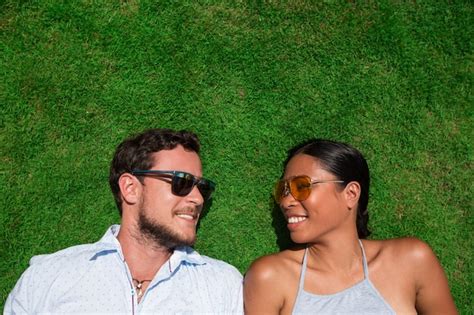 Free Photo Joyful Young Interracial Couple Resting On Lawn