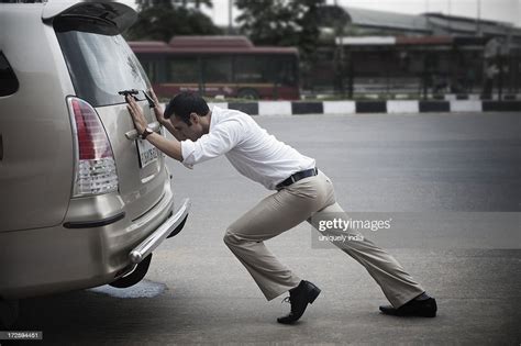 Businessman Pushing His Car High Res Stock Photo Getty Images