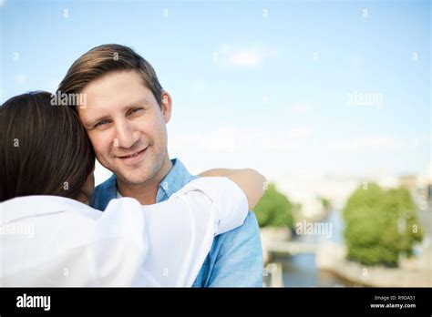 Handsome Man Hugging Girlfriend Stock Photo Alamy