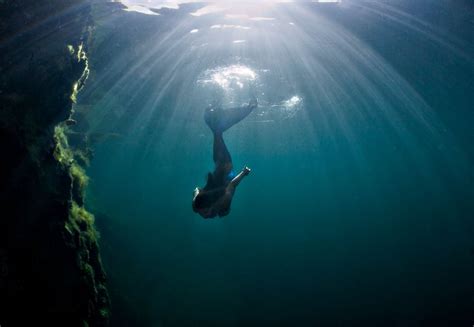 Mermaid In The Ocean Sun Light Dark Blue Water Underwater