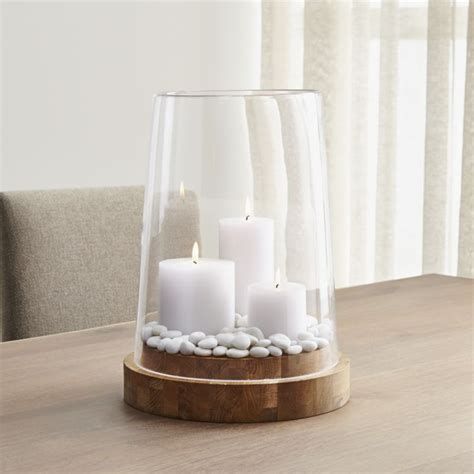 The center holds a pillar candle protected with a glass sleeve where you can add seasonal décor around the perimeter. Shop Ellery Extra Large Hurricane Candle Holder ...