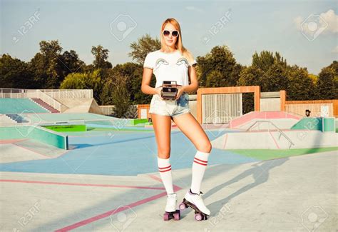 Beautiful Blonde Girl Posing On A Vintage Roller Skates In Denim