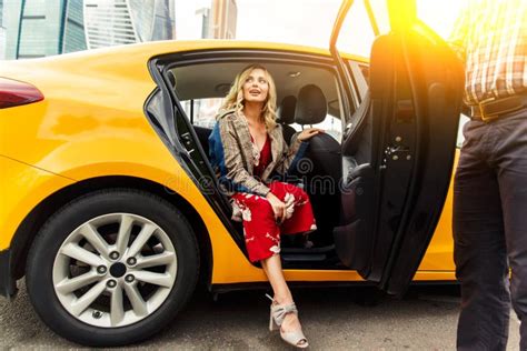 Photo Of Young Blonde In Long Dress Sitting In Back Seat Of Taxi In Afternoon Stock Image