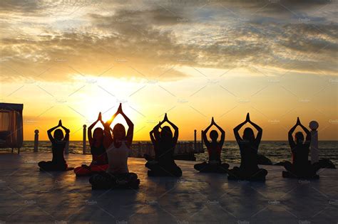 Group Women Doing Yoga At Sunrise Featuring Background Balance And