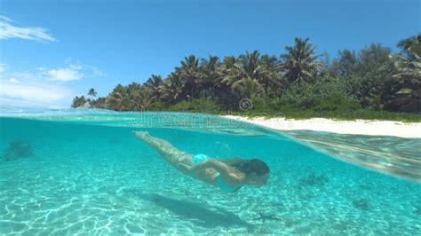 Half Underwater Happy Young Woman In Bikini Diving Near Sunny Tropical