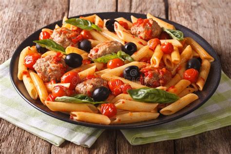 Italian Cuisine Pasta Penne With Meatballs Olives And Tomatoes Stock