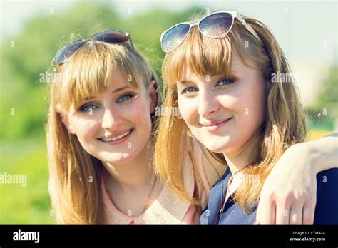Pretty Twins Girls Having Fun At Outdoor Summer Park Young Smiling