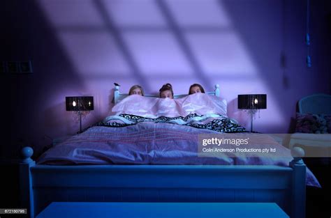 Caucasian Girls Watching Scary Movie In Bed At Night Photo Getty Images