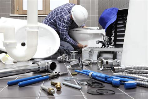 Plumber At Work In A Bathroom Plumbing Repair Service Assemble Stock