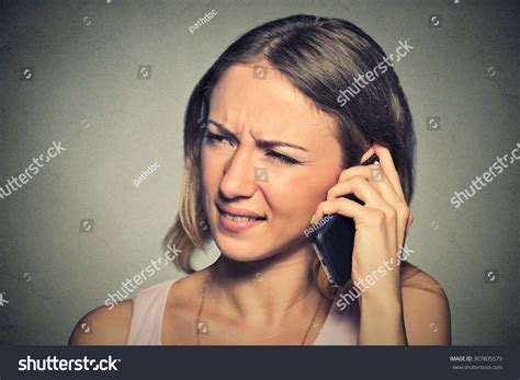 portrait upset sad annoyed unhappy woman talking on cell phone negative human emotion facial