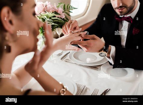 Selective Focus Of Man Putting Wedding Ring On Finger On Surprised