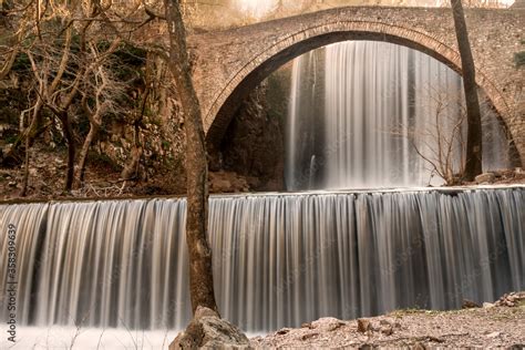 The Double Waterfalls And The Stone Bridge Of Paleokaria In Greece