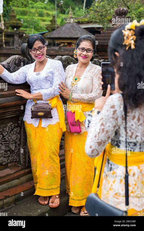 Balinese Women In Traditional Dress At The Pura Tirta Empul Temple In The Village Of Manukaya In