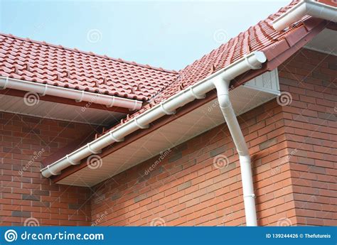As with most industries, the world of gutters has its own vocabulary and specific monikers for the various bits and pieces that comprise its workings. Rain Gutter Pipe System. Close Up On Brick House With Roof ...