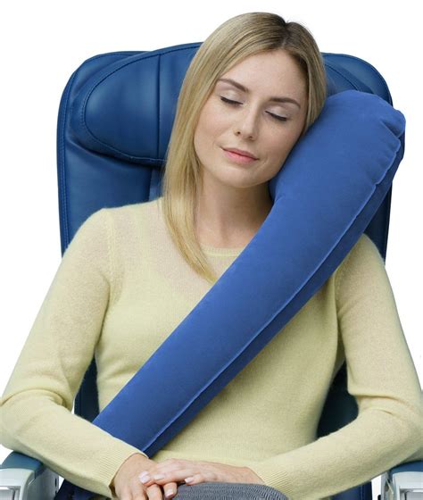 A Woman Sitting In A Blue Chair With A Pillow On Her Back And Head Resting On The Armrest