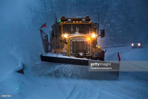 Snowplow Plowing The Highway During Snow Storm High Res Stock Photo