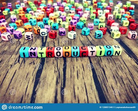 INTRODUCTION Word Of Colourful Cube Alphabets On Wooden Background ...