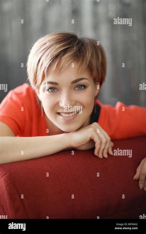 Woman In Red Dress At Home Stock Photo Alamy