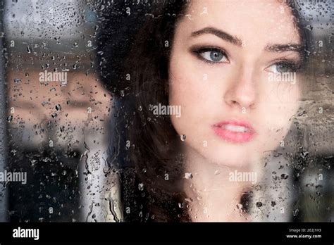 Portrait Of A Beautiful Young Woman Behind A Window Stock Photo Alamy
