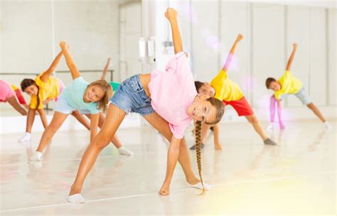 Kids Warming Up In Group Dance Class Doing Stretching Exercises Before