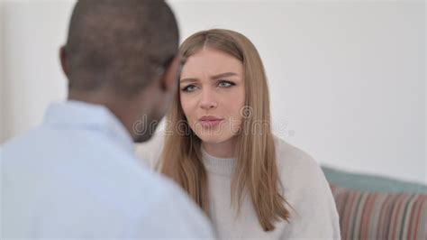 Interracial Couple Having Conversation On Sofa Stock Image Image Of