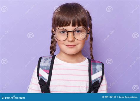 Portrait Of Cute Charming Schoolgirl In Glasses Wearing Backpack
