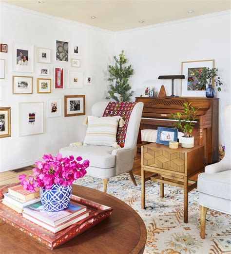 A Living Room Filled With Lots Of Furniture And Pictures On The Wall