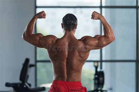 Muscular Man Flexing Muscles Rear Double Biceps Pose Stock Image