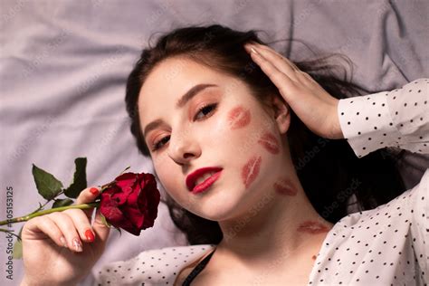Sexy Brunette Woman With Kisses Lipstick Marks On Her Face And Neck