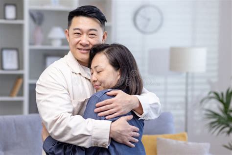 Happy Asian Couple Man And Woman Together At Home Smiling And Hugging