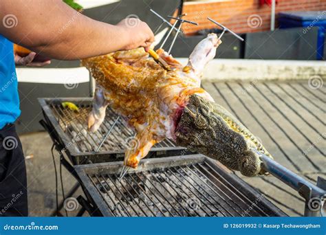 Thai Street Food Fried Crocodile Meat On A Barbeque For Sale