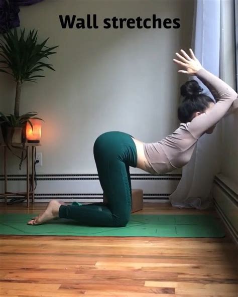 A Woman Is Doing Yoga In Front Of A Window With The Words Wall