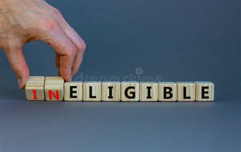 Eligible Or Ineligible Symbol Businessman Turns Wooden Cubes And