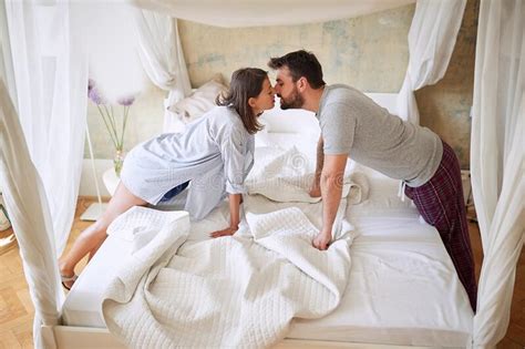 Couple Kissing In The Morning While Making The Bed Bedroom Morning