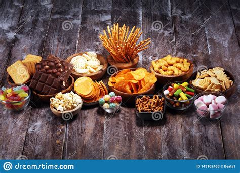 Salty Snacks Pretzels Chips Crackers In Wooden Bowls On Table Stock