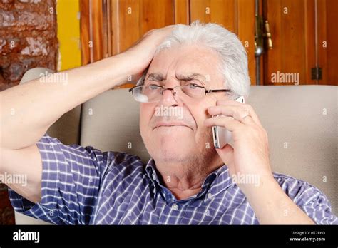 Portrait Of An Old Man Talking On The Phone Indoors Stock Photo Alamy