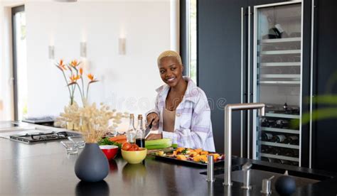 Happy African American Woman Cooking In Kitchen Chopping Vegetables