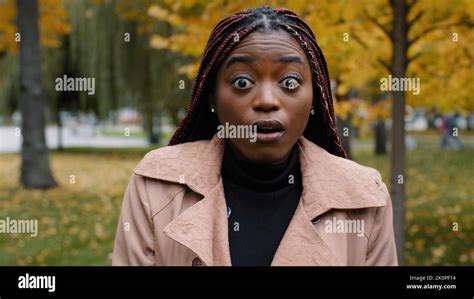 Close Up Stunned African American Woman Standing Outdoor Looking At Camera With Eyes Wide Open