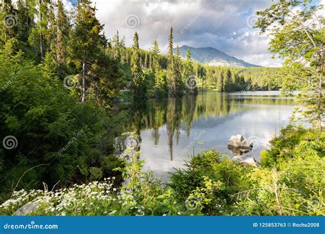 The Landscape Of The Picturesque Lake Surrounded By Mountain Peaks And