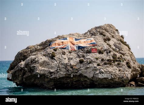 A Large Rock With The Union Jack In Catalan Bay On The East Side Of The