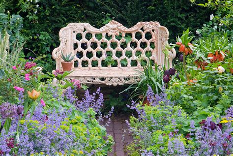 Garden Bench Wrought Iron In Lush Flower Garden Plant And Flower Stock