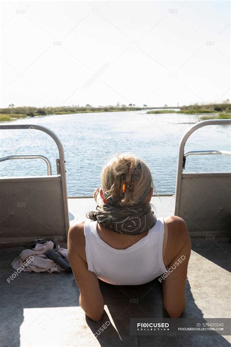 A Woman Relaxing On A Boat On A Waterway — Protected Area Botswana