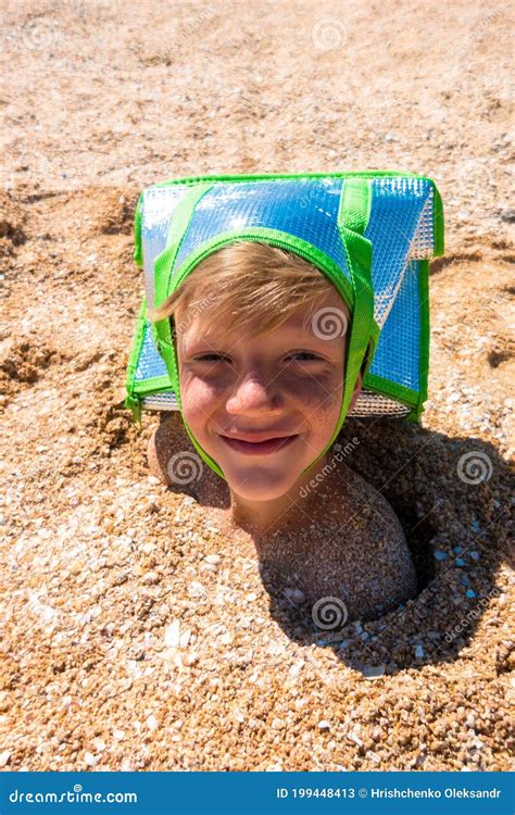 The Boy S Head Is Sticking Out Of The Sand Wearing A Cooler Bag On My