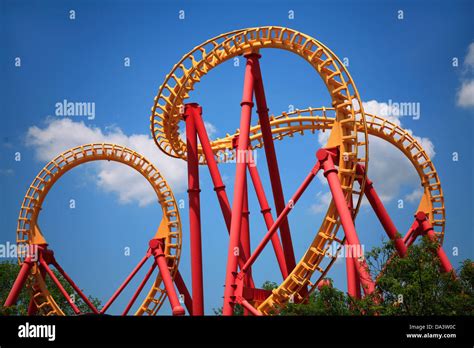 A Colorful Looping Roller Coaster On A Beautiful Sunny Day Stock Photo