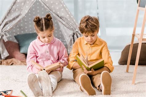 Beautiful Kids Sitting On Carpet And Stock Photo Image Of Read