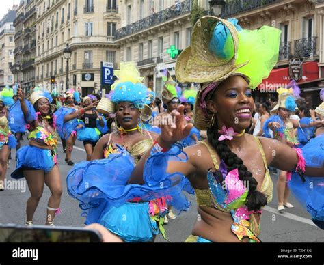 A Troupe Of Female Dancers In Colourful Costume And Headdresses At The Karibean Mass Street